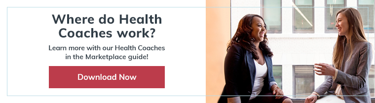 Two women in office smiling and talking