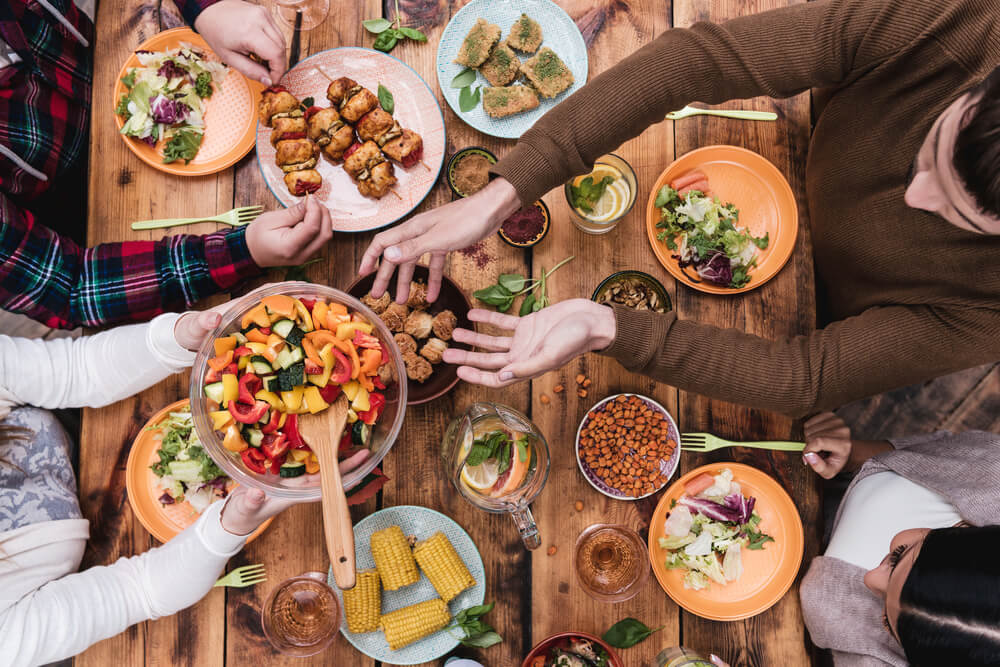 friends sharing food across table